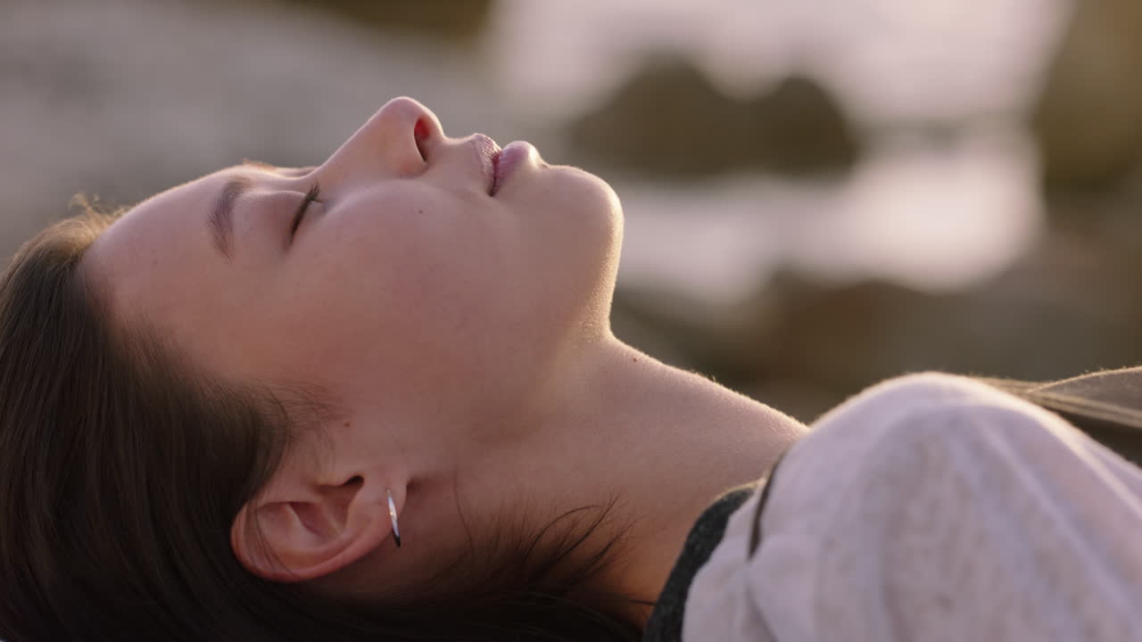 retrato de una hermosa mujer asiática acostada en la playa al atardecer sintiéndose relajada disfrutando de una contemplación pacífica relajándose explorando un estilo de vida despreocupado