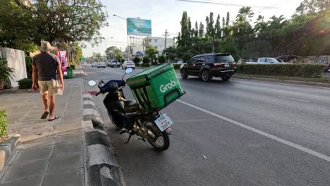 delivery motorcycle parked by a bustling city road