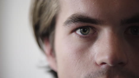 close-up-of-young-caucasian-man-opening-eyes-looking-serious-eyesight-vision
