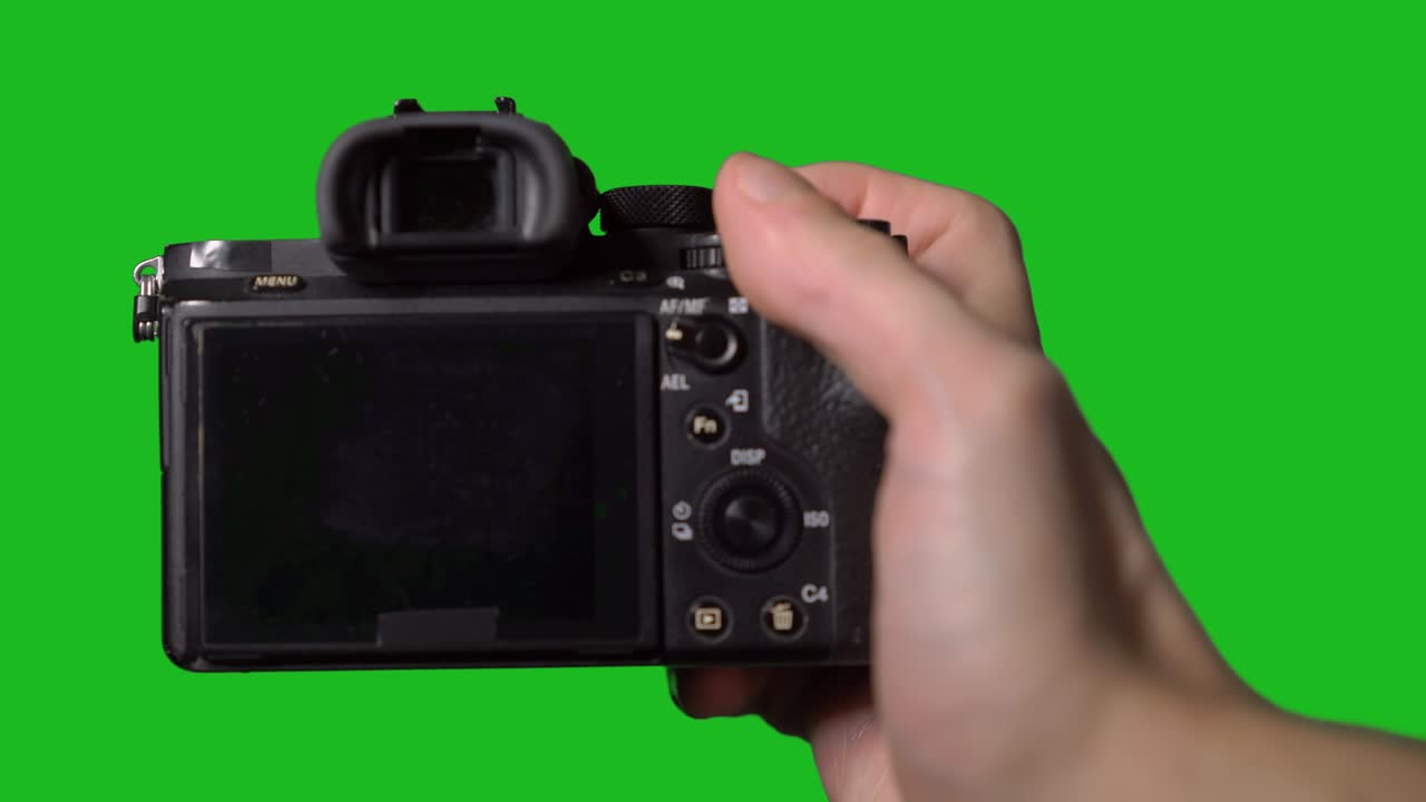 Professional DSLR photo camera with lens at green background. Chroma key