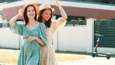 two happy women in straw hats