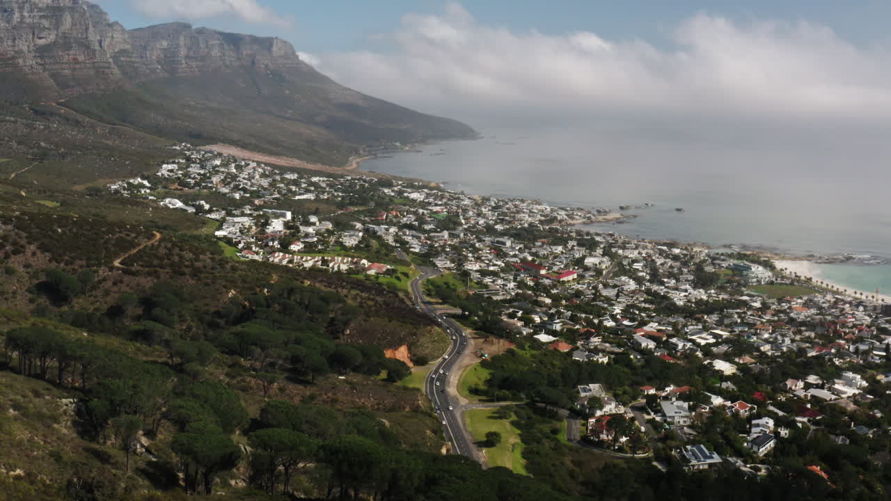 Drone Shot over Camps Bay along the coast of Cape Town, South Africa