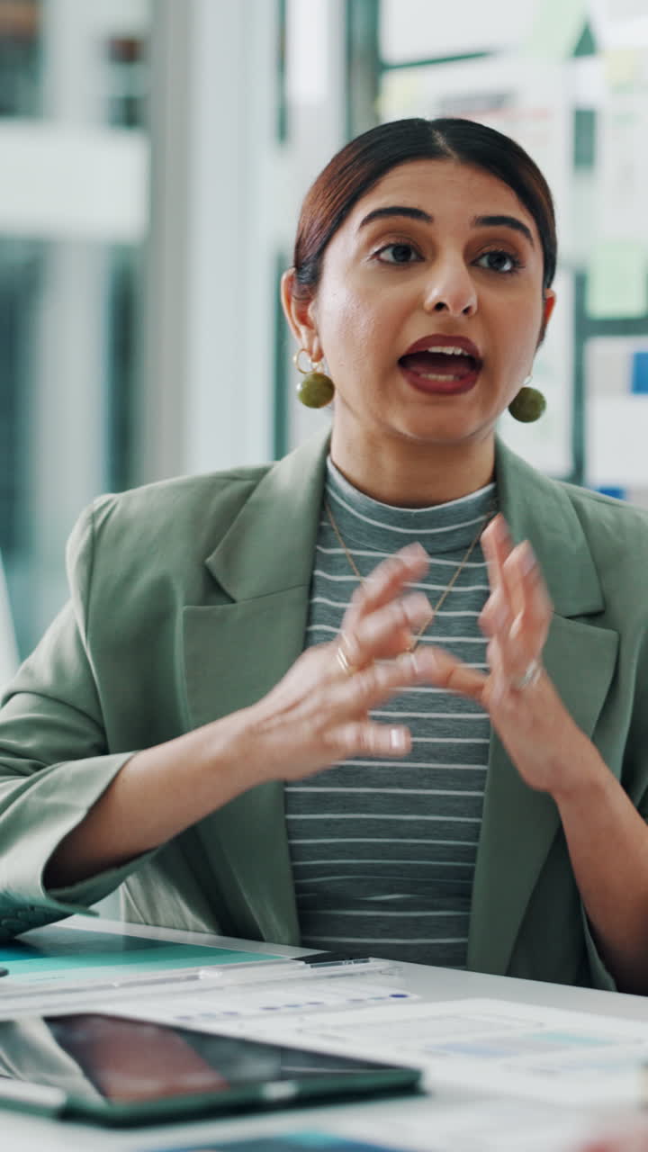 Young Businesswoman Talking and Gesturing During an Office Meeting
