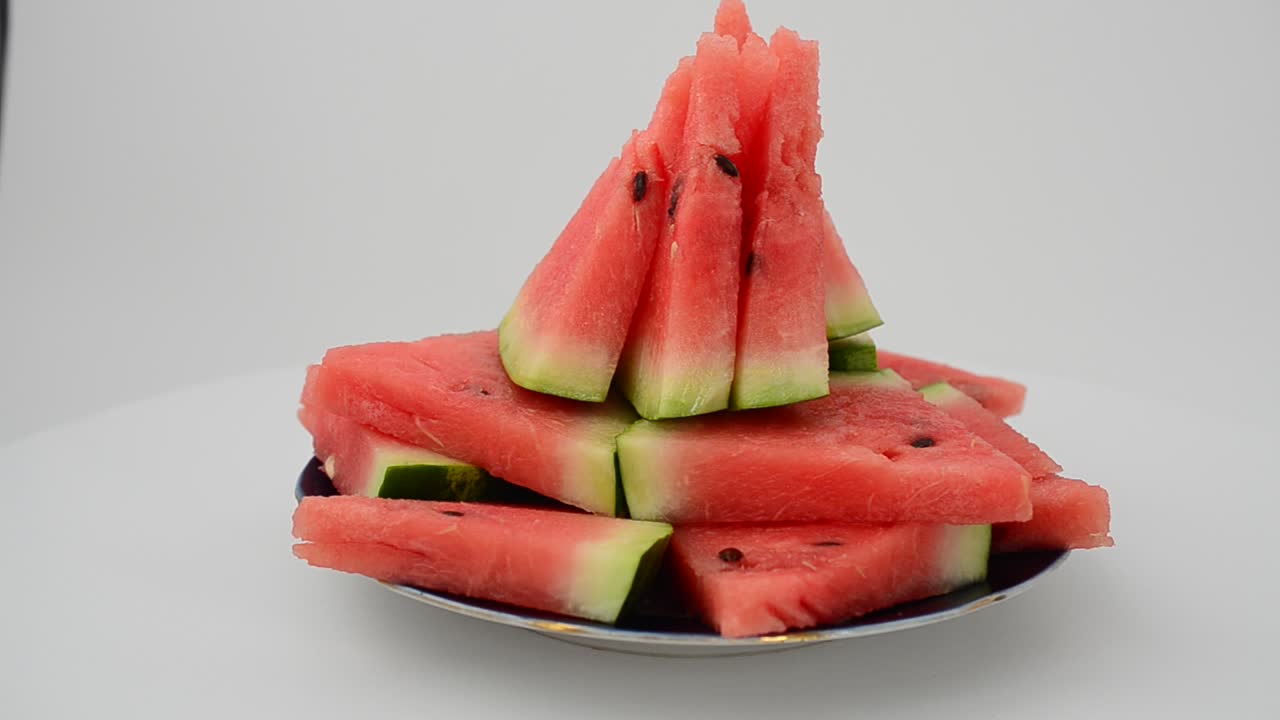 Shooting of a watermelon on a white background. Shooting in the movement