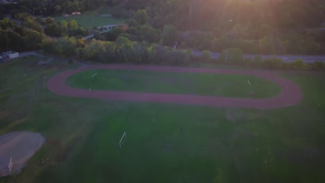 4k drone footage of green soccer field at a park in toronto, canada