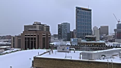 Gray-winter's-day-with-Salt-Lake-City-skyline-and-Wells-Fargo-prominent,-aerial