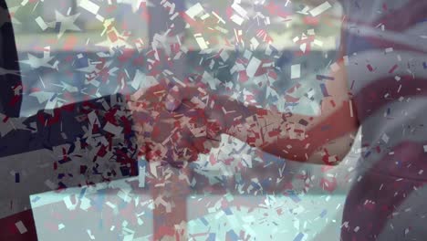 animación de confeti cayendo sobre la bandera estadounidense y el apretón de manos de un hombre de negocios