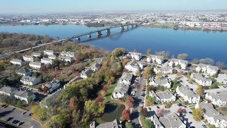 Drone-shot-over-a-neighborhood-in-Tacony,-NJ-showing-the-Tacony-Palmyra-bridge-that-connects-New-Jersey-to-Pennsylvania