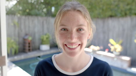 Portrait-of-happy-caucasian-woman-with-blond-hair-in-garden,-slow-motion