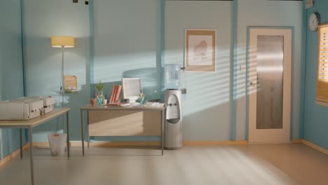 static wide shot of colourful and sunny office space with water cooler