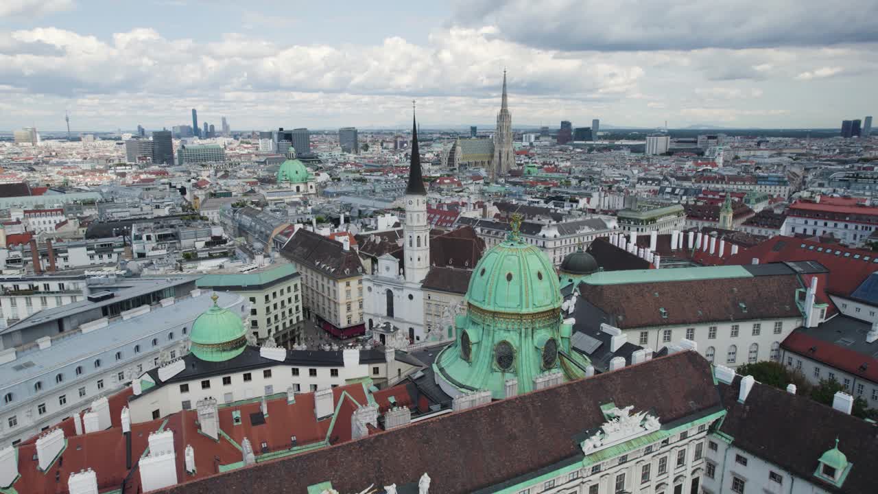 Aerial - Michaelerplatz in Vienna, Austria, showcasing historic architecture, domed roofs, and the city skyline