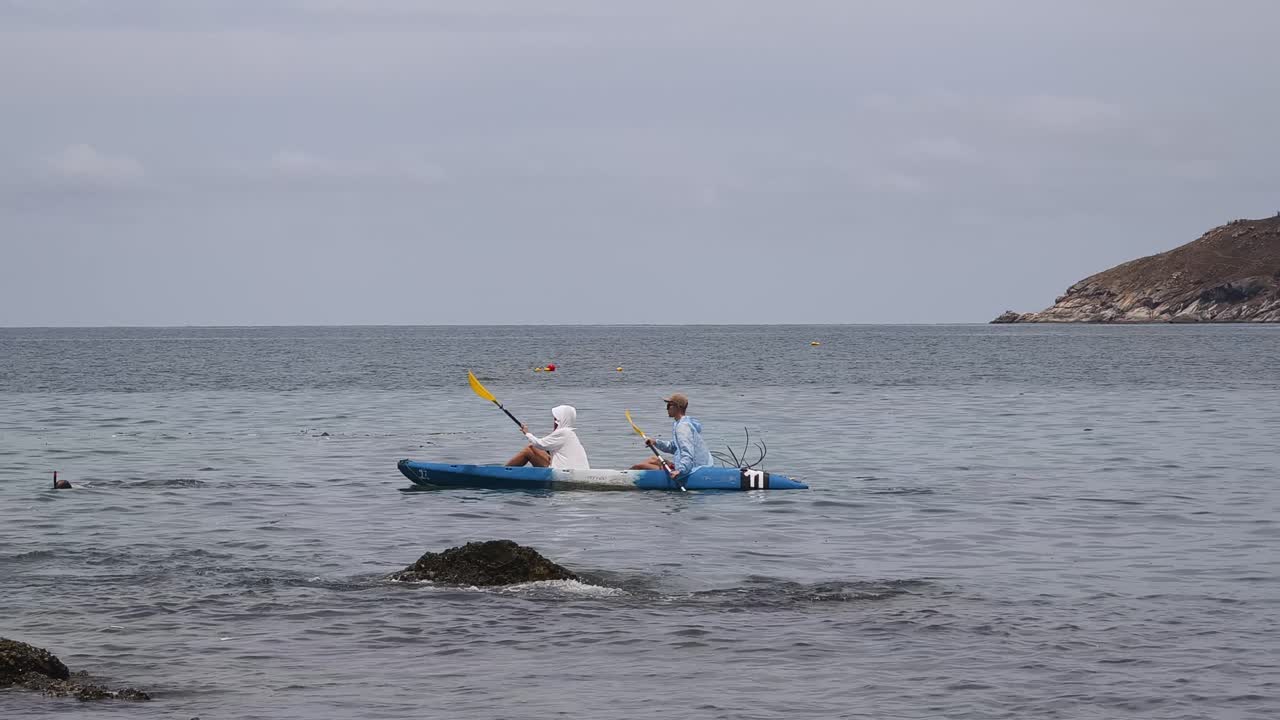 Couple Kayaking in Calm Ocean Waters