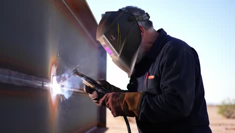 welder working on metal structure