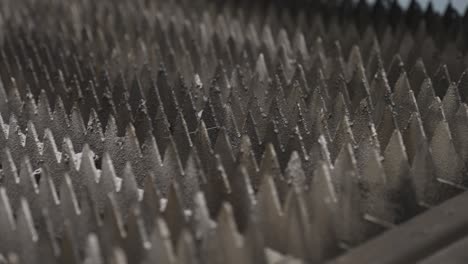 close up of pointy tray with metal sheet moving into cnc machine for cutting