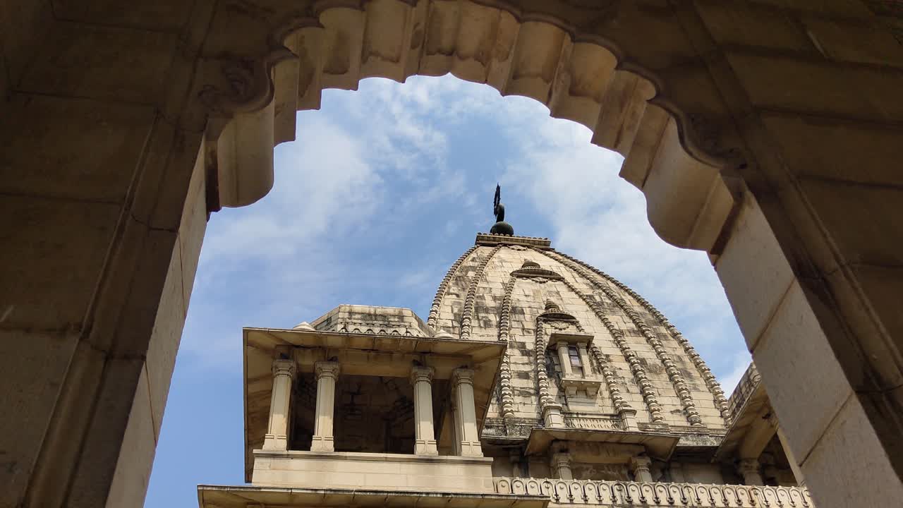 Stunning upward view of Kirti Mandir dome framed by arched stone entry, highlighting Indian heritage in Vadodara.