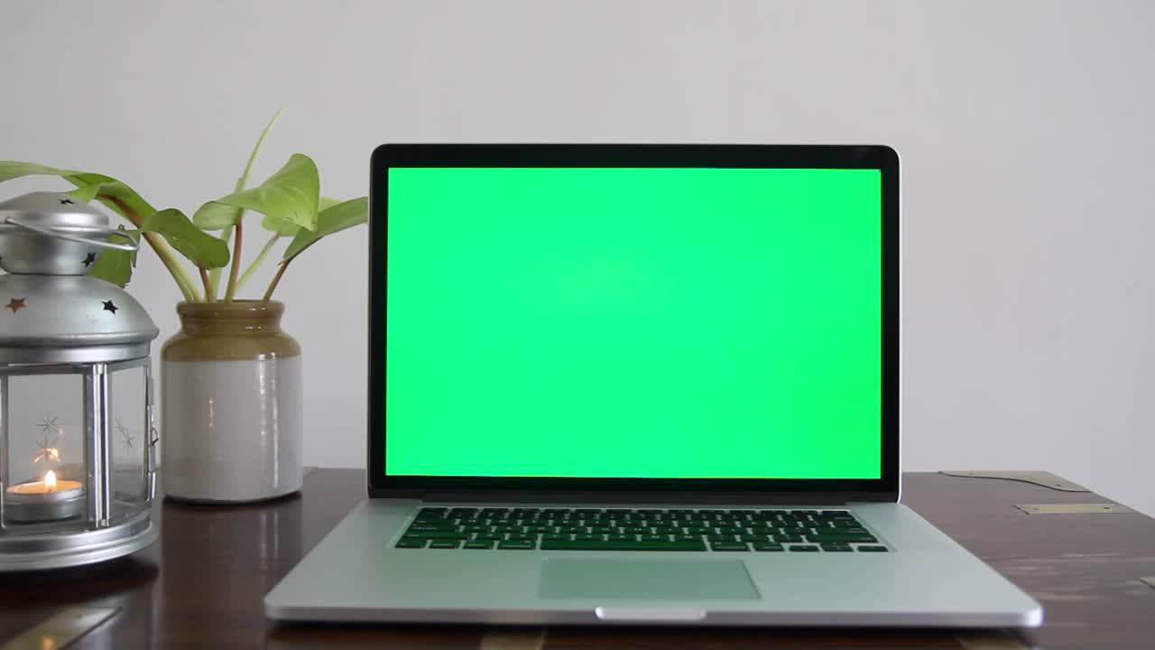 A laptop with a green screen which can be removed to place any content as per the requirement