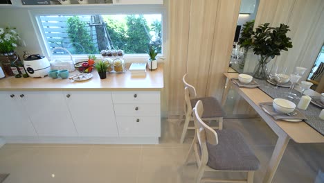 simple and chic dining area with pantry and garden view, no people