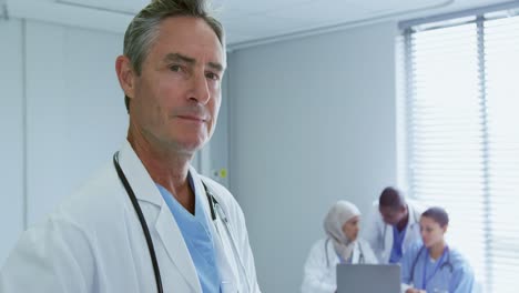 Close-up-of-Caucasian-male-doctor-looking-at-his-colleagues-in-hospital