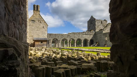 motion time lapse of boyle abbey medieval ruin in county roscommon in ireland as a historical sightseeing landmark with dramatic clouds in the sky on a summer day