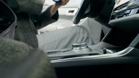 woman in car, using phone and accessories