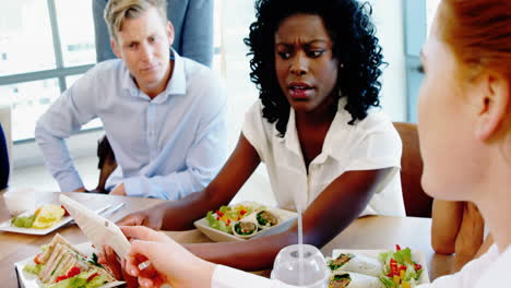 executives discussing over digital tablet