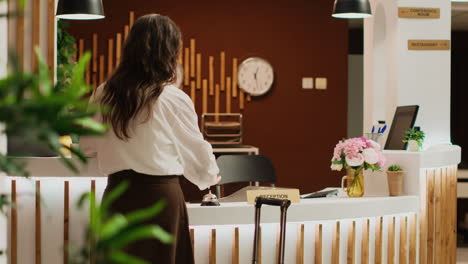 woman ringing service bell at reception