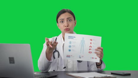 angry indian female doctor explaining medical report to patient green screen