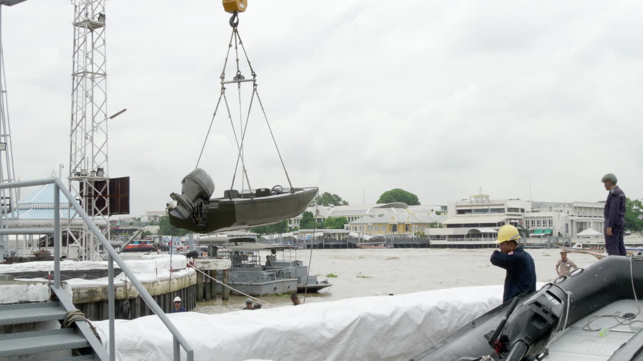 Royal Thai Navy staff deploying speedboats using a crane to be used for patrolling the waters and banks of Chao Phraya River, in Bangkok, Thailand.