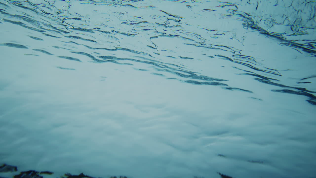 Therapeutic crystal clear water turns from white to dark blue in gradient as it rolls into clean barrel