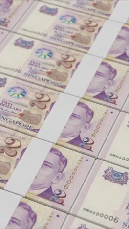 vertical video of 2 singapore dollar banknotes printed by a money press