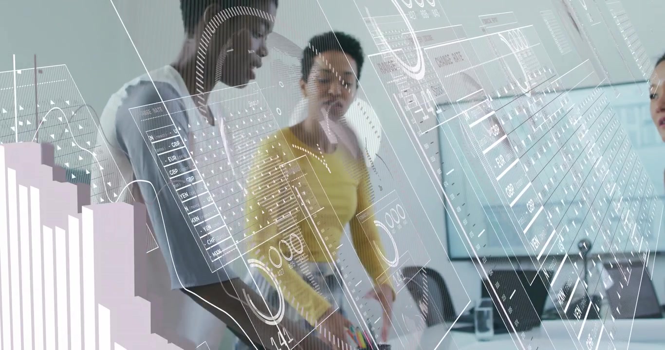 Design colleagues exploring blueprints at table, woman tapping tablet revealing animated charts