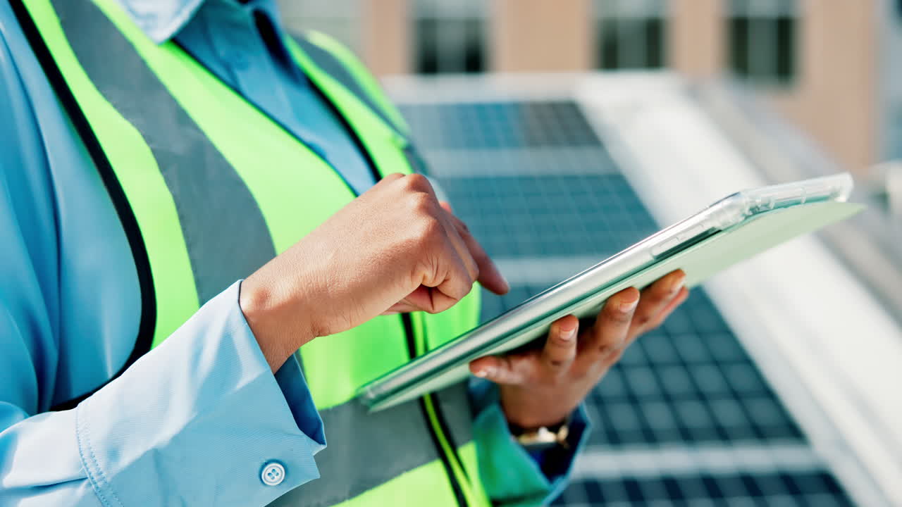 Engineer using tablet on solar panel installation