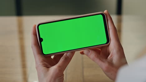 lady boss fingers hold mockup telephone at office. woman watching green screen