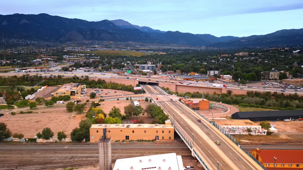 Colorado Springs, USA, 22 July 2025: Roads and railways crossing the cityscape. Drone flight over Colorado-Springs, Colorado, USA surrounded by the mountains