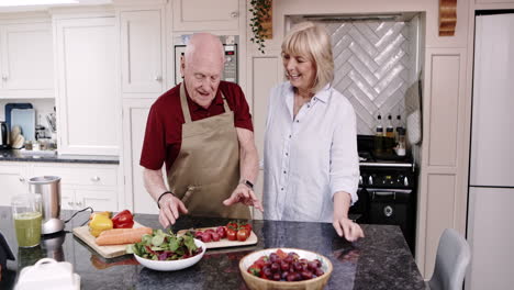elderly couple preparing food in kitchen