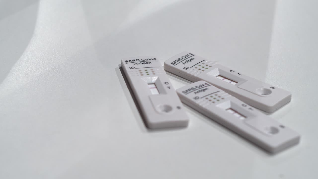 Three COVID Antigen Rapid tests, two positive and one negative