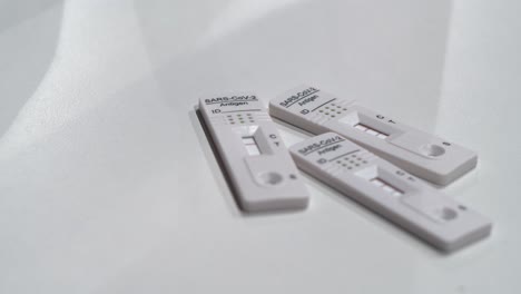 three covid antigen rapid tests, two positive and one negative