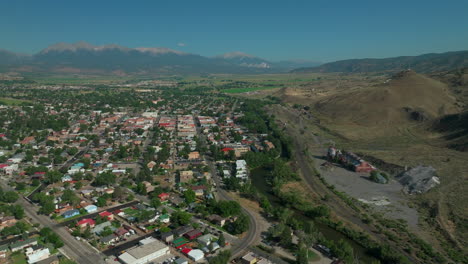 Aerial-cinematic-drone-mid-summer-downtown-Salida-S-Lime-Mill-Colorado-near-Buena-Vista-on-Arkansas-River-Riverside-Park-Scout-surfing-wave-biking-hiking-rafting-Rocky-Mountain-backward-movement