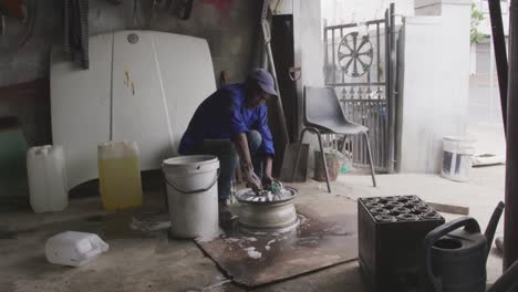 african man cleaning a wheel