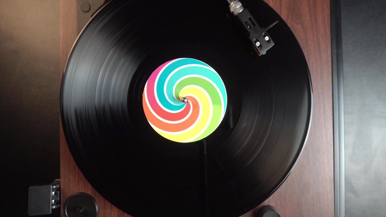 Starting Playback of Vinyl Record With Optical Illysion Sticker With Rainbow Colors, Top Down View