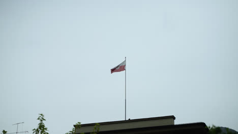 flag waving on a building in innsbruck, austria in slow motion