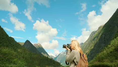 woman hiking and taking pictures in the norwegian fjords