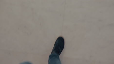 male feet going down a marble steps