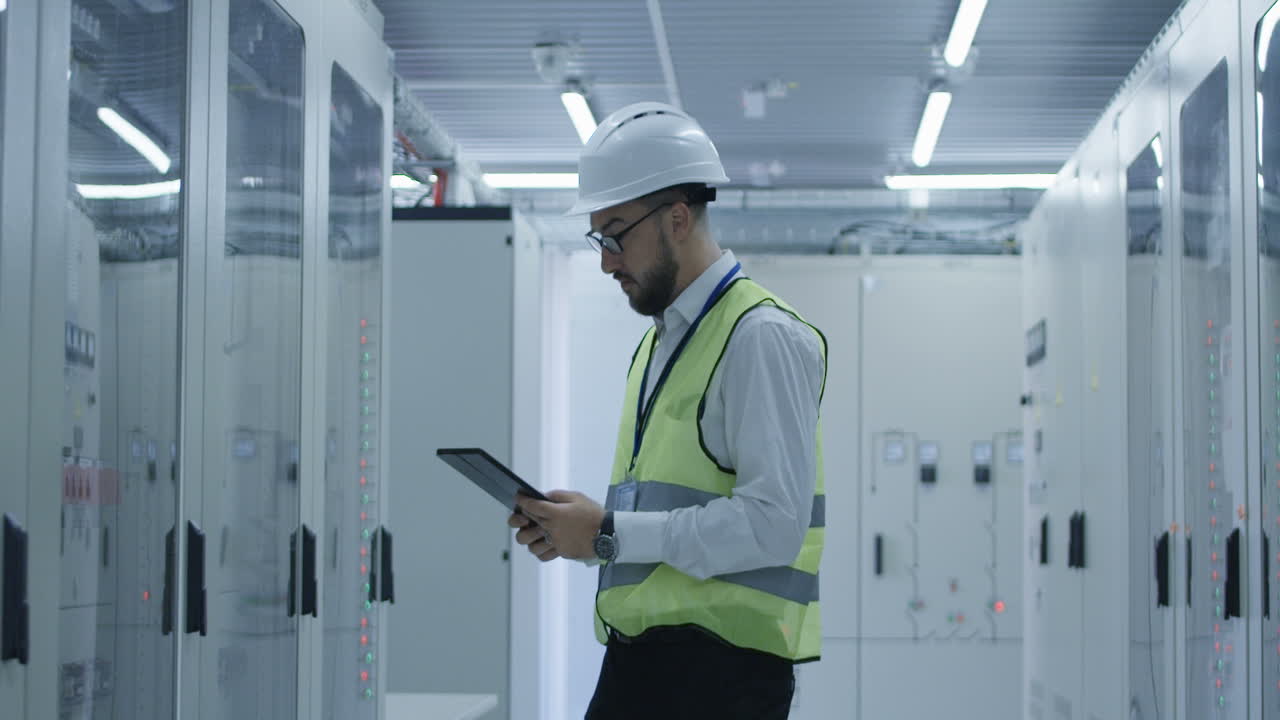 Engineer inspecting equipment in a server room