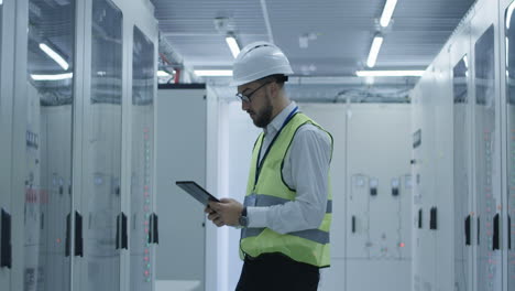 Engineer inspecting equipment in a server room