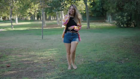 woman walking in park and talking on phone