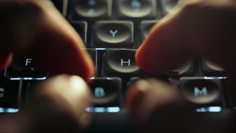 Close-up-footage-of-young-businessman-hands-busy-working,-searching-and-studying-by-typing-on-glowing-keyboard-in-the-dark-for-send-emails-and-surf-on-a-web-browser