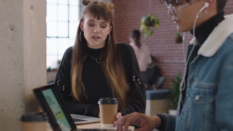 beautiful caucasian business woman student chatting to colleague sharing ideas enjoying working together brainstorming in modern office