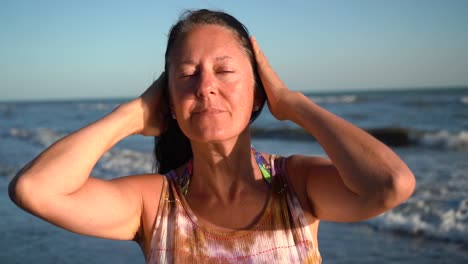 Adult-Woman-At-The-Shore-Smiling-In-Front-Of-Camera