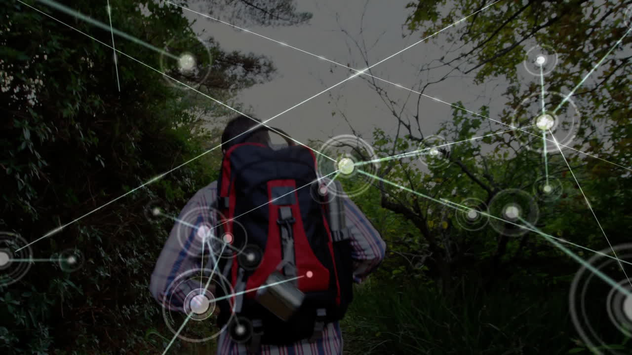 Man hiking along forest trail, highlighting augmented reality network nodes overlay for technology